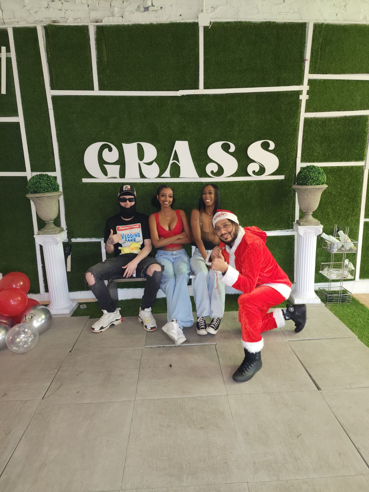 Two guests posing at a GRASS event backdrop