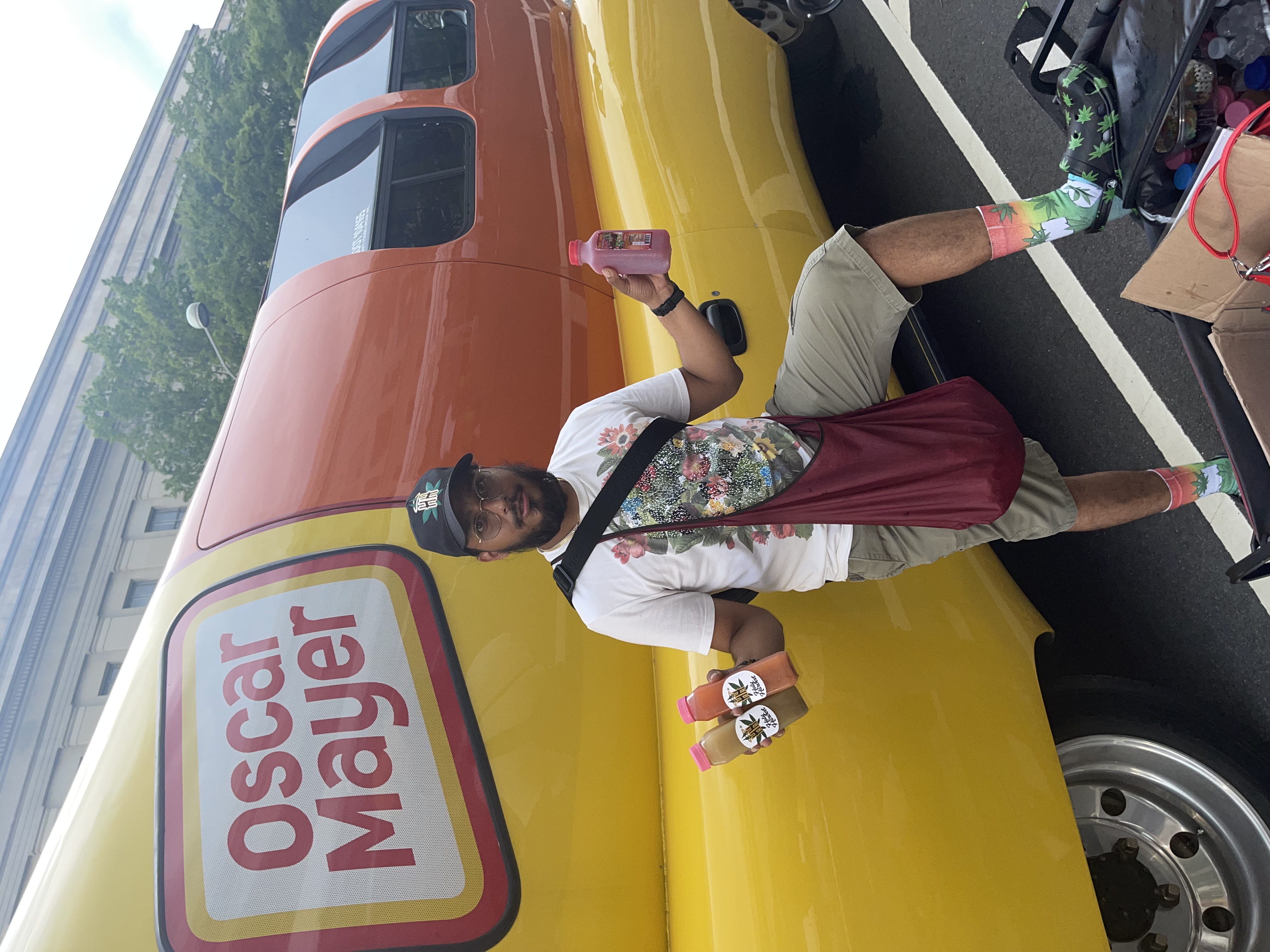 Founder sharing bottled lemonade beside a colorful Oscar Mayer vehicle