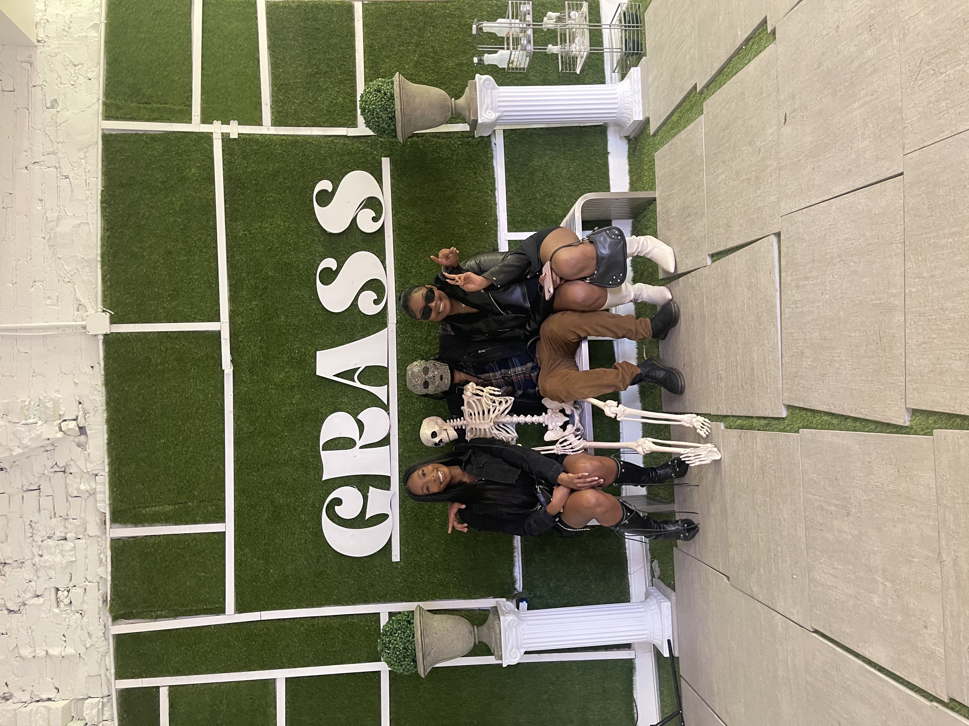 Guests posing together at a GRASS event backdrop